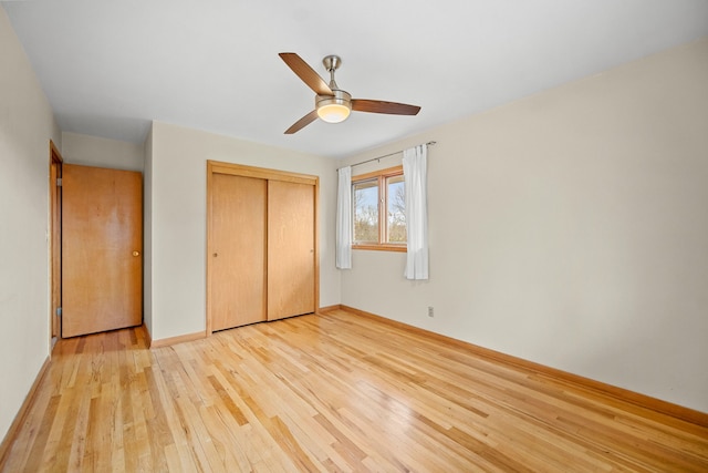 unfurnished bedroom with ceiling fan, a closet, and light hardwood / wood-style flooring