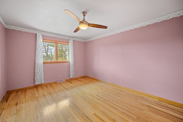 unfurnished room with ceiling fan, crown molding, and light wood-type flooring