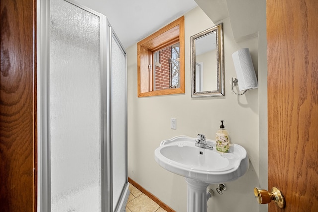 bathroom with tile patterned flooring and an enclosed shower