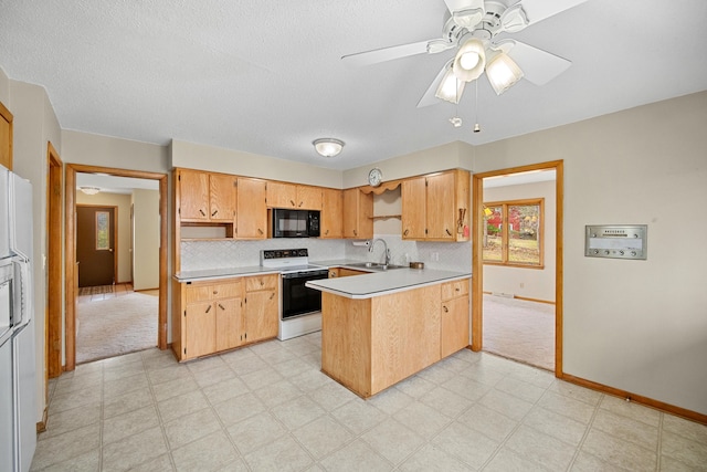 kitchen featuring ceiling fan, sink, kitchen peninsula, white appliances, and light carpet