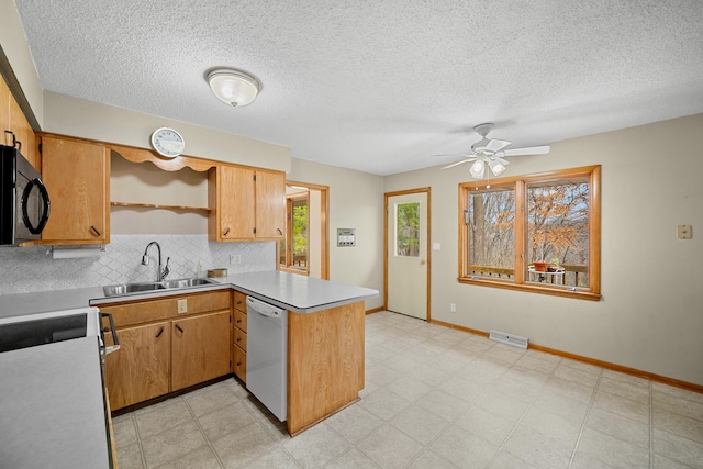 kitchen featuring kitchen peninsula, backsplash, white dishwasher, ceiling fan, and sink