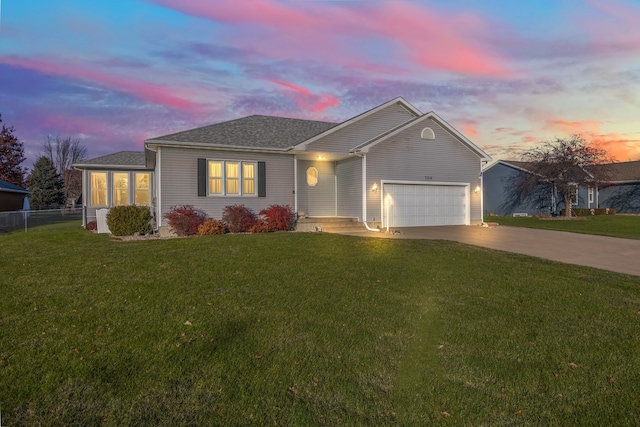 ranch-style house with a lawn and a garage