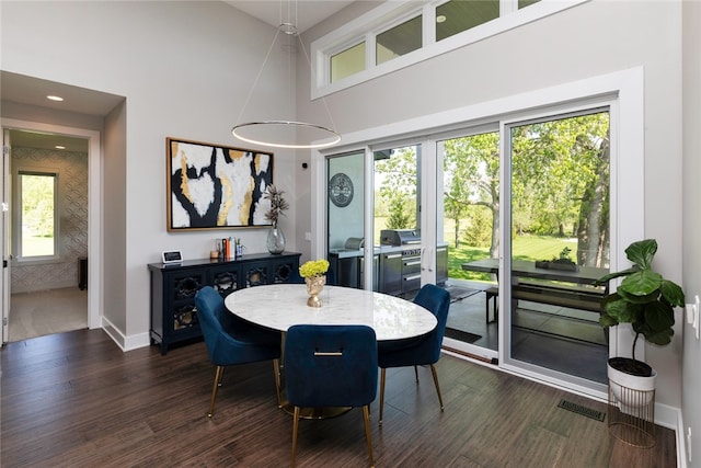 dining room with dark hardwood / wood-style floors