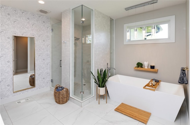 bathroom featuring shower with separate bathtub