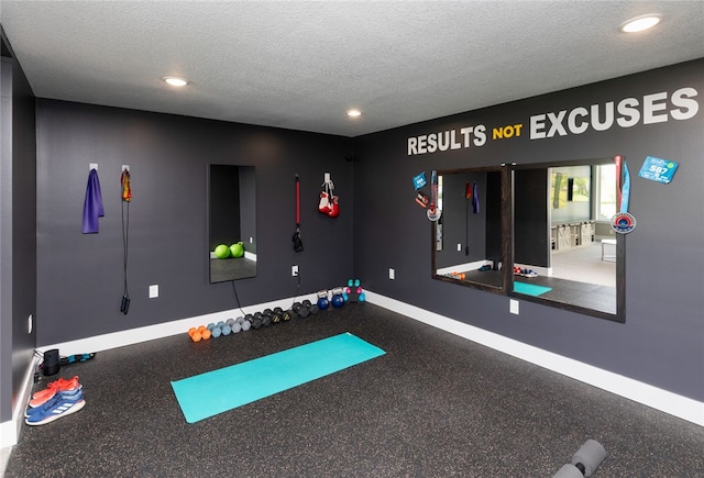 exercise room with a textured ceiling