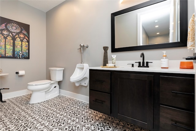 bathroom with tile patterned floors, vanity, and toilet