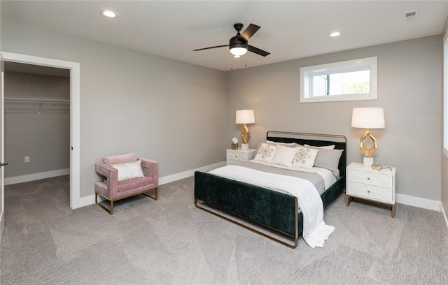 carpeted bedroom featuring a closet and ceiling fan