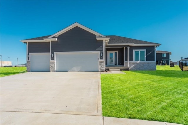 view of front of house with a garage and a front lawn