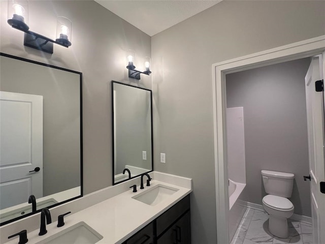 bathroom featuring vanity and toilet