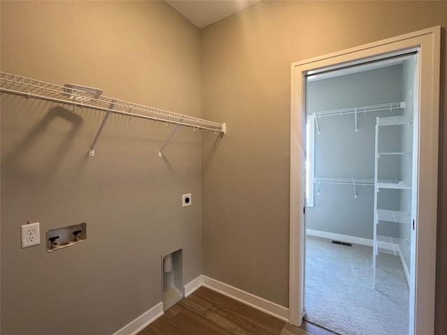 laundry area featuring electric dryer hookup, dark hardwood / wood-style floors, and hookup for a washing machine