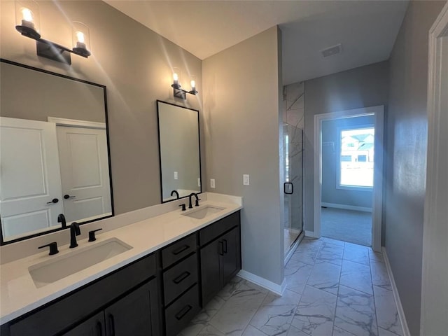 bathroom featuring vanity and an enclosed shower