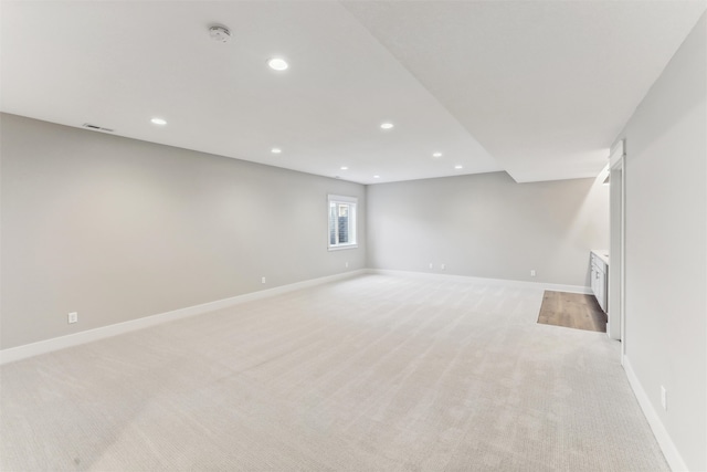 basement featuring light colored carpet