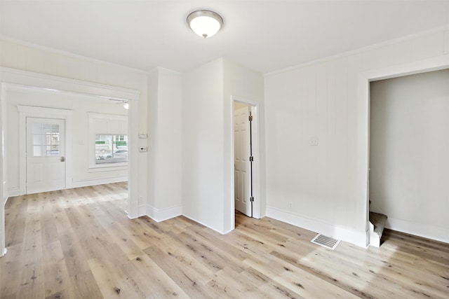 unfurnished room featuring light wood-type flooring and crown molding