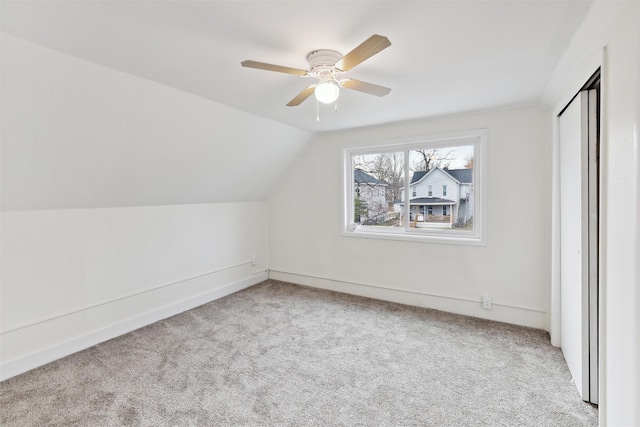 additional living space featuring lofted ceiling, ceiling fan, and light carpet