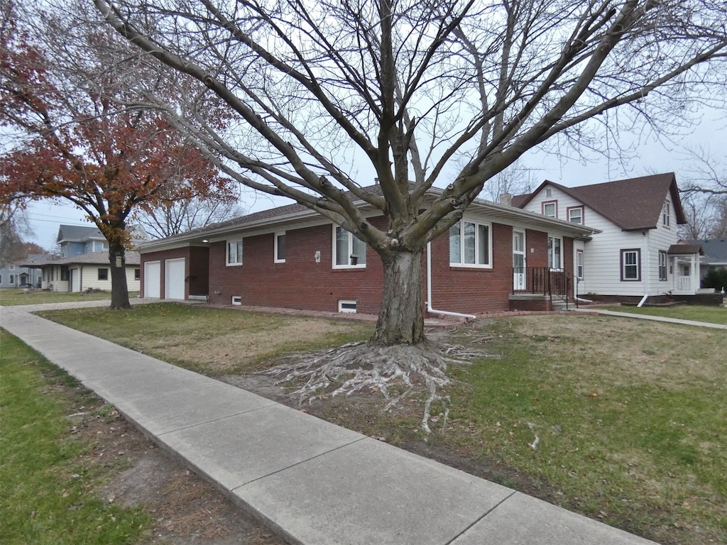 view of front of property with a front lawn and a garage