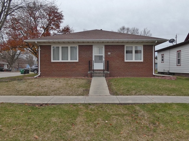 bungalow-style home featuring a front lawn