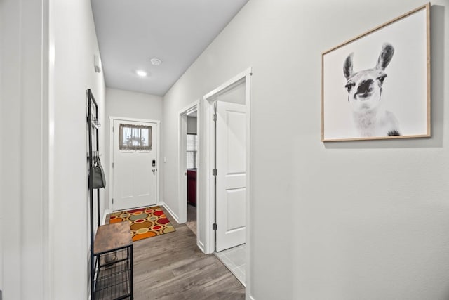 hallway with light hardwood / wood-style floors