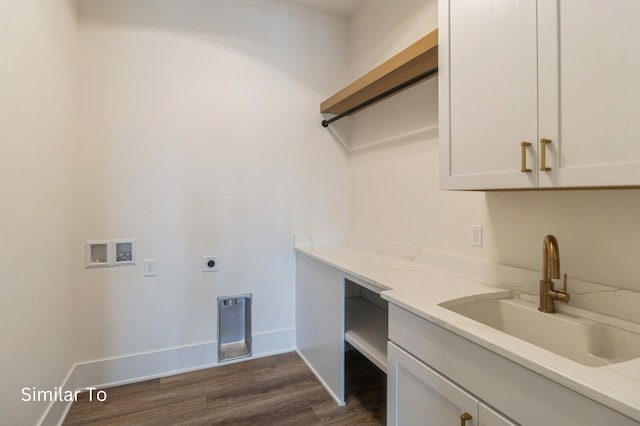 clothes washing area featuring cabinets, hookup for a washing machine, electric dryer hookup, dark wood-type flooring, and sink