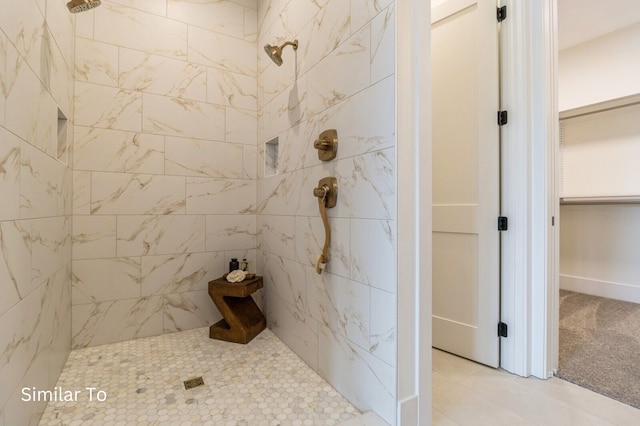 bathroom with tile patterned flooring and tiled shower