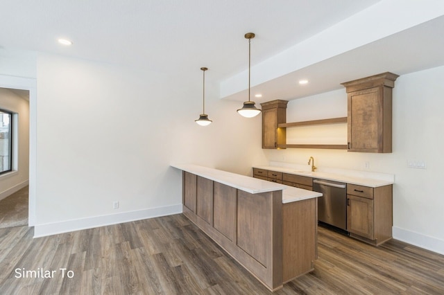 kitchen with stainless steel dishwasher, dark hardwood / wood-style floors, pendant lighting, and kitchen peninsula