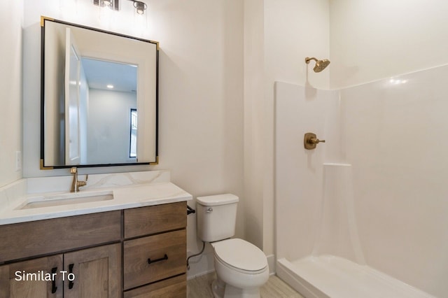 bathroom with vanity, toilet, and walk in shower