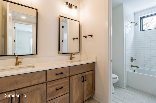 full bathroom with tiled shower / bath combo, toilet, and vanity