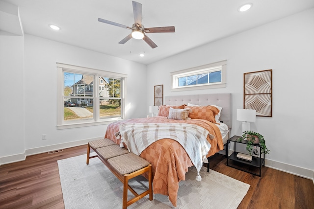 bedroom with dark hardwood / wood-style flooring and ceiling fan