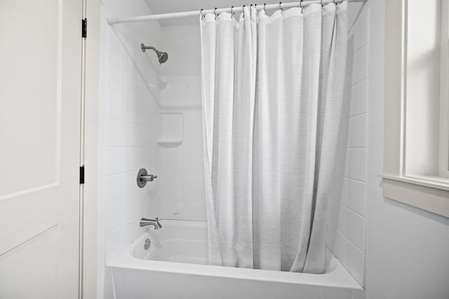 bathroom with shower / bathtub combination with curtain