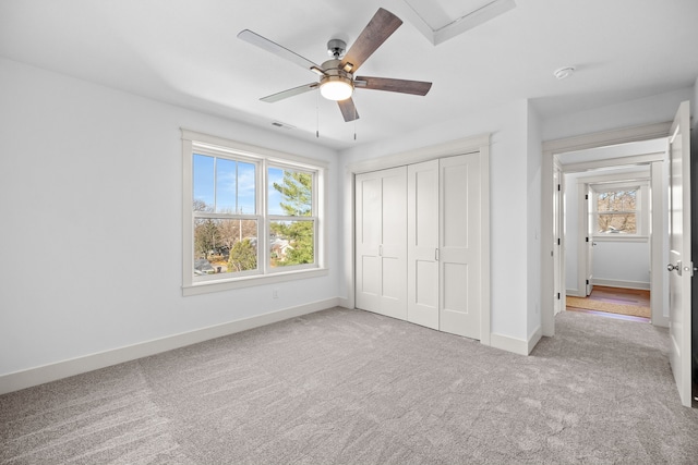 unfurnished bedroom with a closet, ceiling fan, and light colored carpet