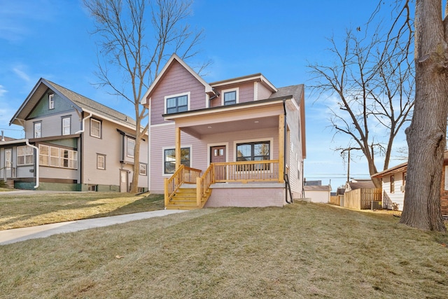 view of front of home featuring covered porch and a front yard