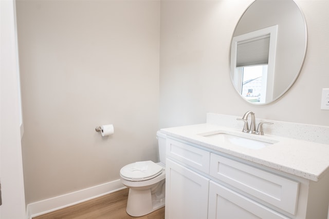 bathroom featuring hardwood / wood-style flooring, vanity, and toilet