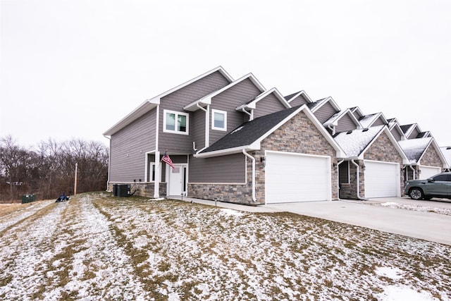 view of front of home with cooling unit and a garage