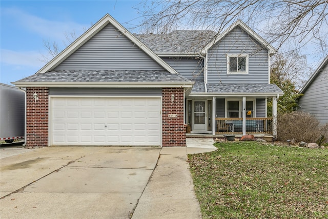 view of front of home featuring a porch, a garage, and a front lawn