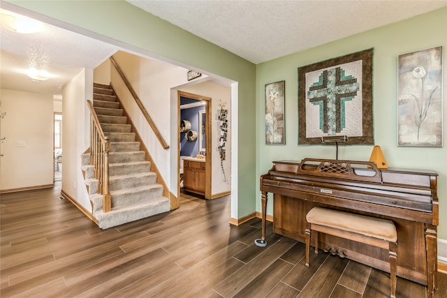 misc room featuring hardwood / wood-style floors and a textured ceiling