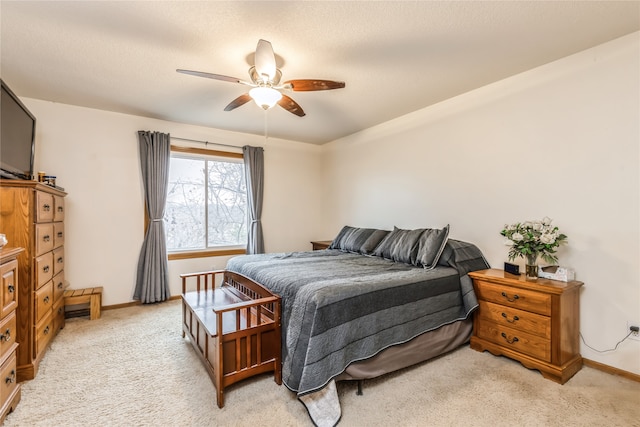 carpeted bedroom with ceiling fan and a textured ceiling