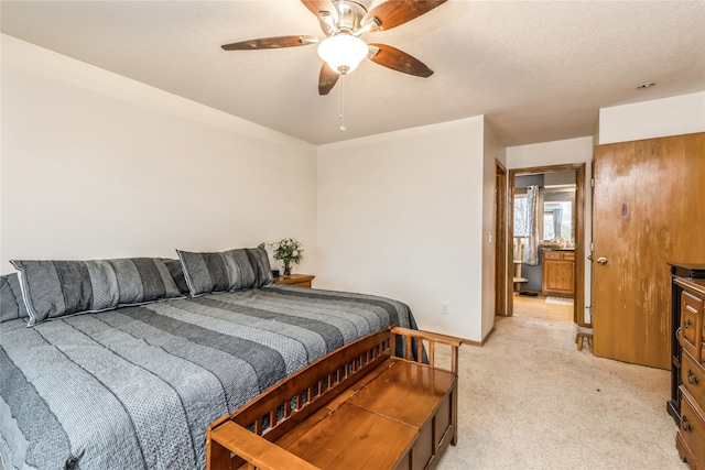 carpeted bedroom featuring a textured ceiling and ceiling fan