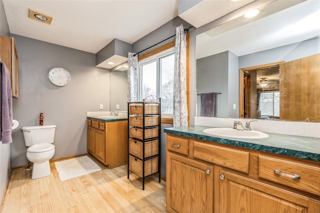 bathroom featuring hardwood / wood-style floors, vanity, and toilet