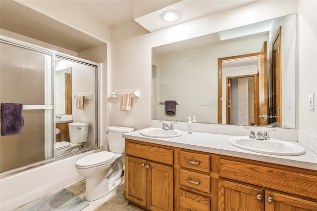 full bathroom with toilet, vanity, and combined bath / shower with glass door