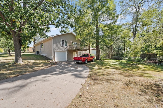 view of side of property featuring a lawn, a deck, and a garage