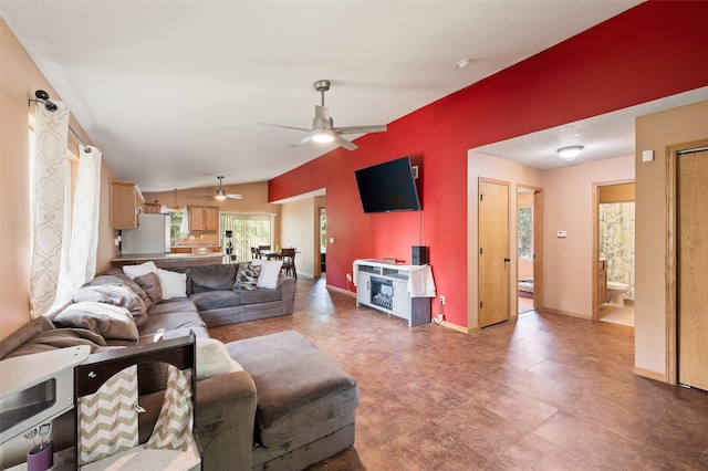 living room featuring ceiling fan and vaulted ceiling