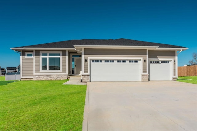 prairie-style home with a garage and a front yard