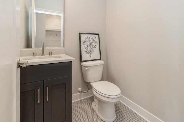 bathroom with tile patterned floors, vanity, and toilet