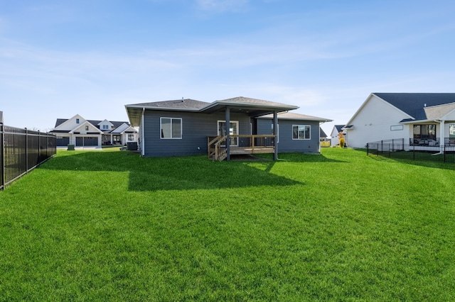 rear view of property featuring a yard