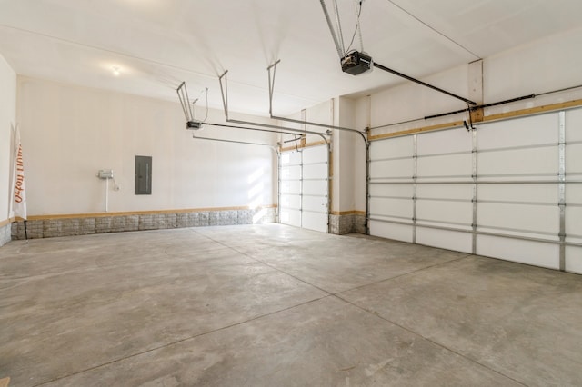 garage with electric panel and a garage door opener