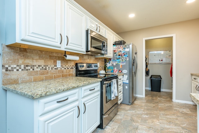 kitchen featuring decorative backsplash, light stone counters, white cabinets, and stainless steel appliances