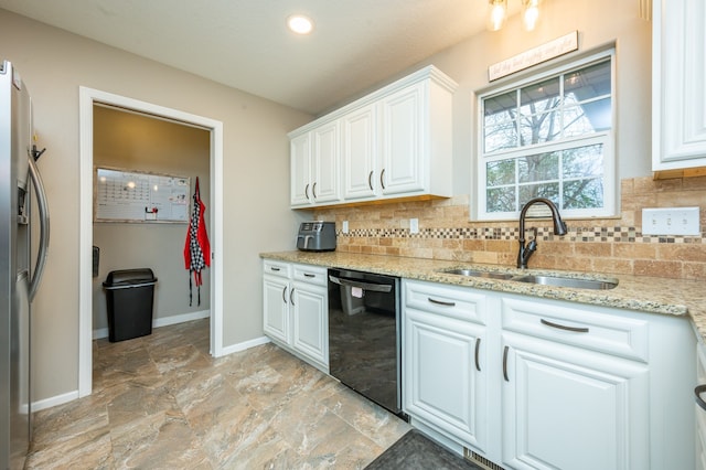 kitchen featuring decorative backsplash, stainless steel fridge, sink, black dishwasher, and white cabinetry