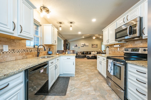 kitchen with white cabinetry, sink, stainless steel appliances, tasteful backsplash, and lofted ceiling