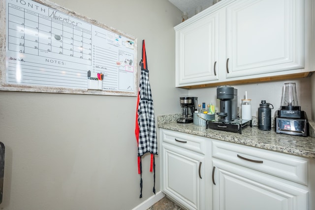 kitchen with white cabinets and light stone counters