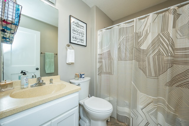 bathroom featuring vanity, toilet, and a textured ceiling