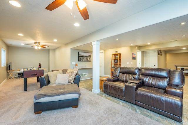 living room featuring ornate columns and light carpet